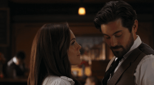 A Man And A Woman Are Kissing With The Words Oh What The Heck Below Them GIF