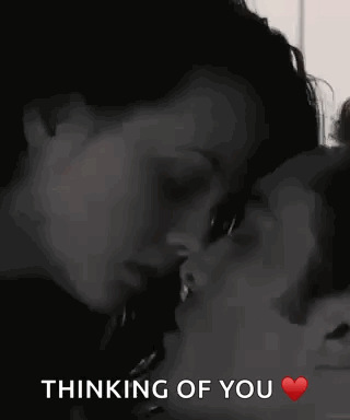 A Man And A Woman Are Kissing With The Words `` Thinking Of You '' Written Below Them . GIF