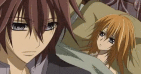 A Man And A Woman Are Laying In Bed Together . GIF