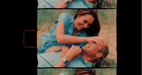 A Man And A Woman Are Laying In The Grass GIF
