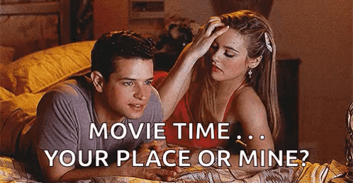 A Man And A Woman Are Laying On A Bed And The Woman Is Putting Her Hand On The Man 'S Forehead . GIF