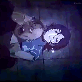 a man and a woman are laying on top of each other on the floor .