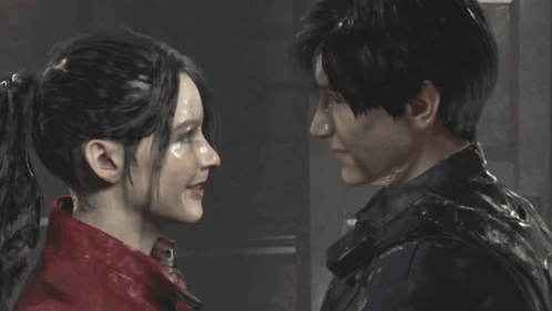 A Man And A Woman Are Looking At Each Other And Smiling GIF