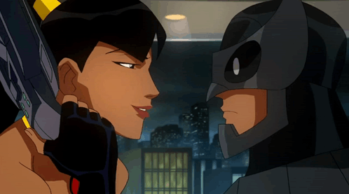 A Man And A Woman Are Looking At Each Other And The Man Is Wearing A Mask GIF