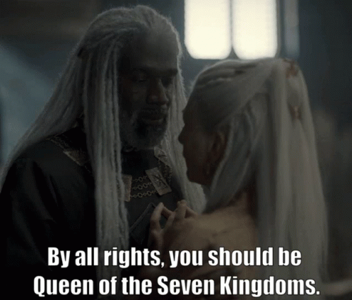A Man And A Woman Are Looking At Each Other And The Man Says By All Rights You Should Be Queen GIF