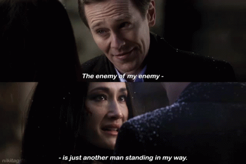 a man and a woman are looking at each other and the man says the enemy of my enemy