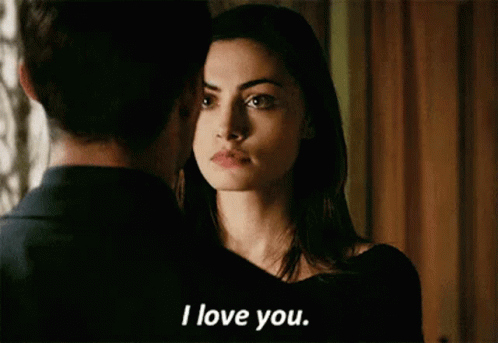 A Man And A Woman Are Looking At Each Other And The Woman Is Saying I Love You . GIF