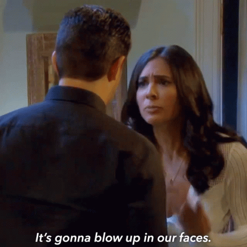 A Man And A Woman Are Looking At Each Other And The Woman Is Saying It 'S Gonna Blow Up In Our Faces GIF