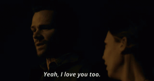 A Man And A Woman Are Looking At Each Other And The Woman Says Yeah I Love You Too GIF