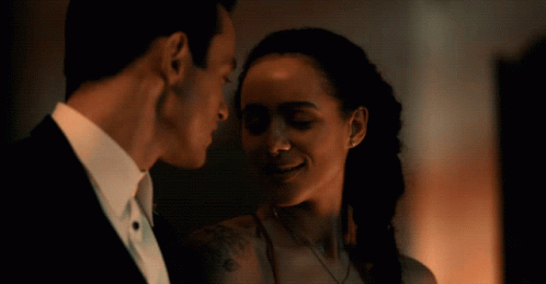 A Man And A Woman Are Looking At Each Other GIF