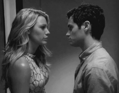 A Man And A Woman Are Looking At Each Other . GIF