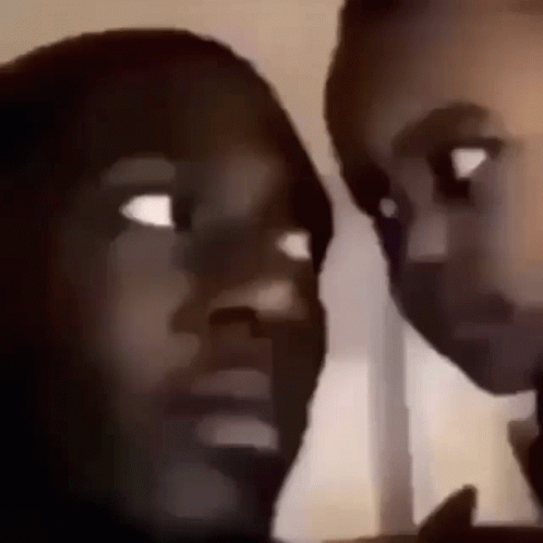 A Man And A Woman Are Looking At Each Other In A Blurry Photo . GIF