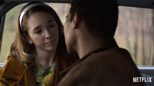 A Man And A Woman Are Looking At Each Other In A Car With Netflix Written On The Bottom GIF