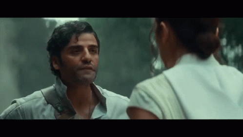 A Man And A Woman Are Looking At Each Other In A Movie . GIF