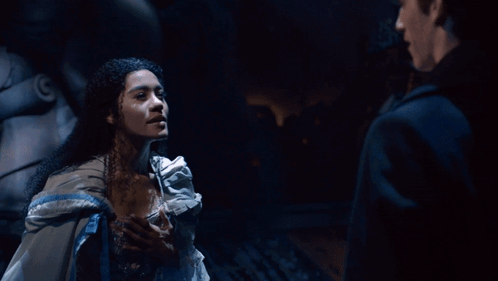 A Man And A Woman Are Looking At Each Other GIF