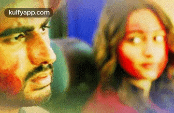 A Man And A Woman Are Looking At Each Other On A Plane . GIF