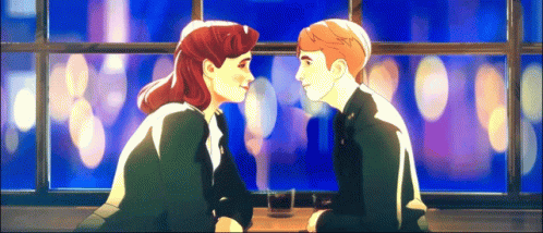 A Man And A Woman Are Looking At Each Other While Sitting At A Table GIF