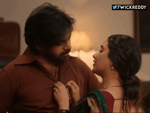 A Man And A Woman Are Looking At Each Other With A 7Wickreddy Sticker In The Corner GIF