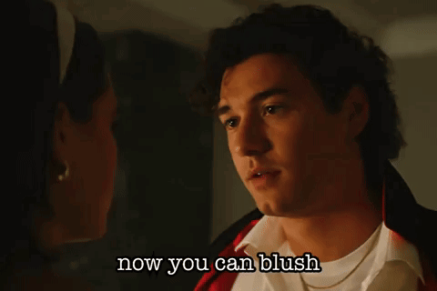 A Man And A Woman Are Looking At Each Other With The Words Now You Can Blush Below Them GIF