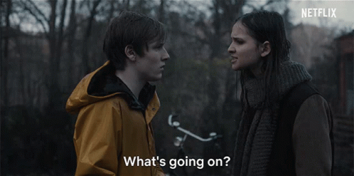 A Man And A Woman Are Looking At Each Other With The Words What 'S Going On GIF