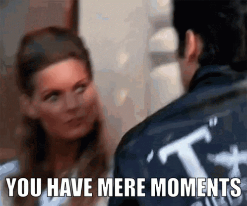 A Man And A Woman Are Looking At Each Other With The Words " You Have Mere Moments " Below Them GIF