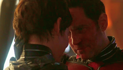 a man and a woman are looking at each other with their eyes closed