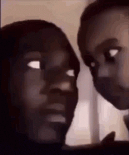 A Man And A Woman Are Looking At Each Other With Their Eyes Closed . GIF