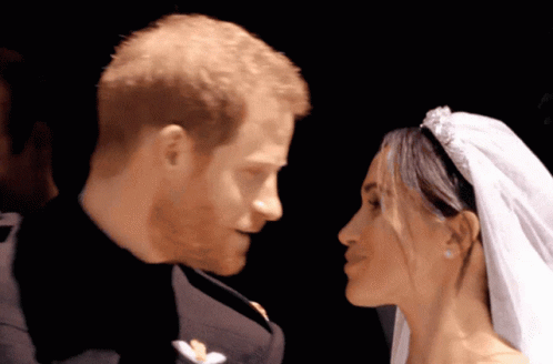 A Man And A Woman Are Looking At Each Other With Their Eyes Closed GIF