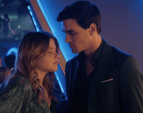 A Man And A Woman Are Looking At Each Other With Their Eyes Closed GIF