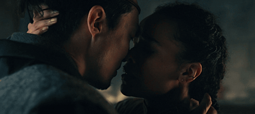 A Man And A Woman Are Looking At Each Other With Their Eyes Closed GIF