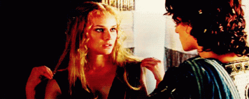 A Man And A Woman Are Looking At Each Other . GIF
