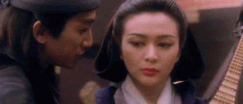 A Man And A Woman Are Looking At Each Other . GIF