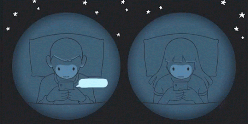 A Man And A Woman Are Looking At Their Phones GIF
