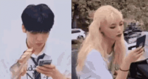 A Man And A Woman Are Looking At Their Phones . The Man Is Wearing A Tie And The Woman Is Blonde . GIF