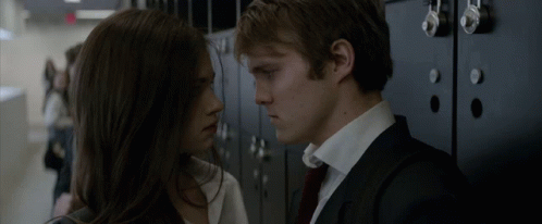 A Man And A Woman Are Looking Into Each Other 'S Eyes GIF