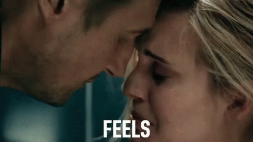 A Man And A Woman Are Looking Into Each Other 'S Eyes And The Woman Is Crying . GIF
