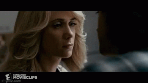 A Man And A Woman Are Looking Into Each Other 'S Eyes . GIF