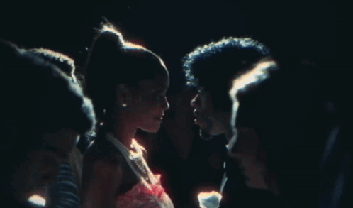 A Man And A Woman Are Looking Into Each Other 'S Eyes GIF