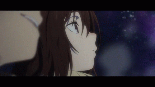 A Man And A Woman Are Looking Up At The Stars In The Night Sky . GIF