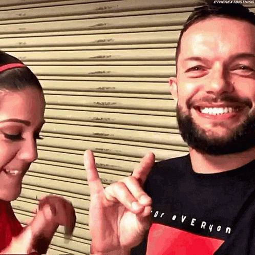 A Man And A Woman Are Making A Heart Shape With Their Hands . GIF