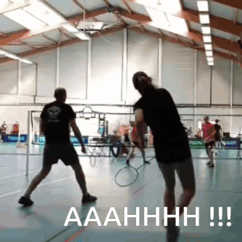 A Man And A Woman Are Playing Badminton In A Gym And The Caption Says Aaahhhh !!! GIF