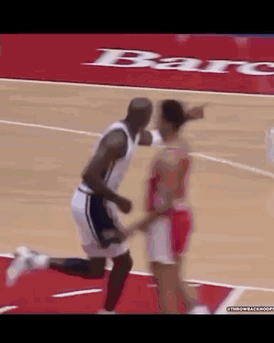 A Man And A Woman Are Playing Basketball On A Court With A Bar Advertisement In The Background .. GIF