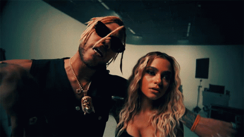 A Man And A Woman Are Posing For A Picture And The Man Is Wearing Sunglasses GIF