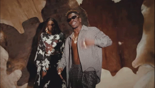 A Man And A Woman Are Posing For A Picture GIF