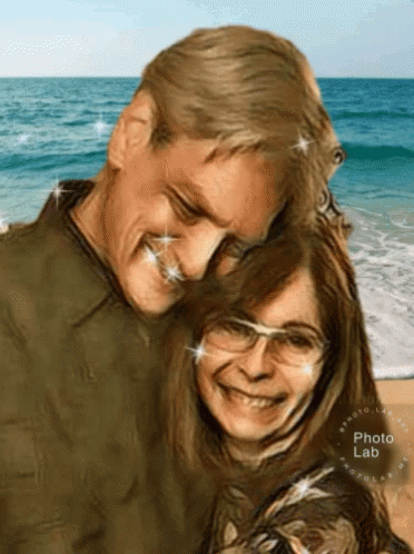 A Man And A Woman Are Posing For A Picture On The Beach With The Photo Lab Logo In The Corner GIF