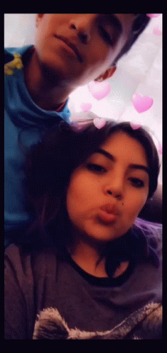 A Man And A Woman Are Posing For A Picture Together GIF