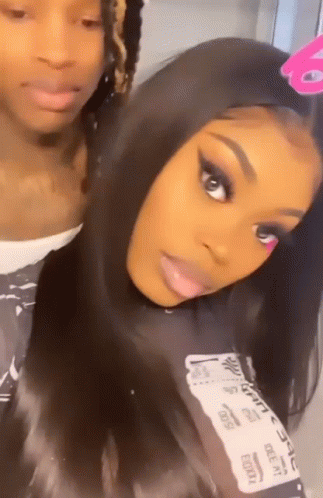 A Man And A Woman Are Posing For A Picture . GIF