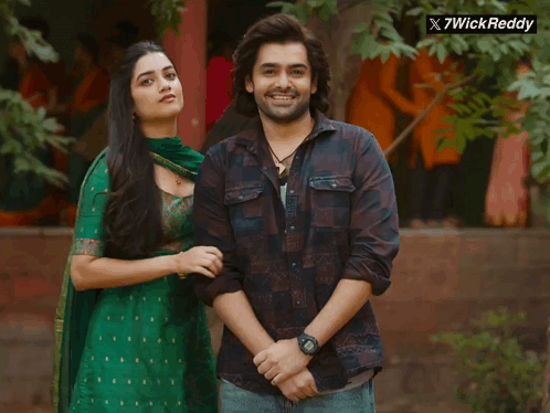 A Man And A Woman Are Posing For A Picture With A X7wick Reddy Logo In The Corner GIF