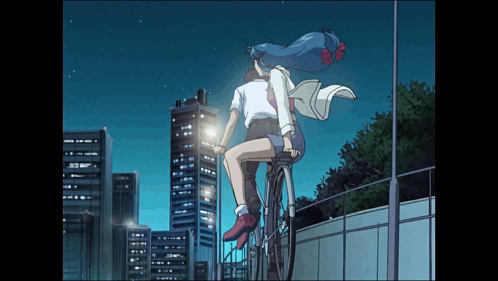 A Man And A Woman Are Riding A Bike In Front Of A City Skyline GIF