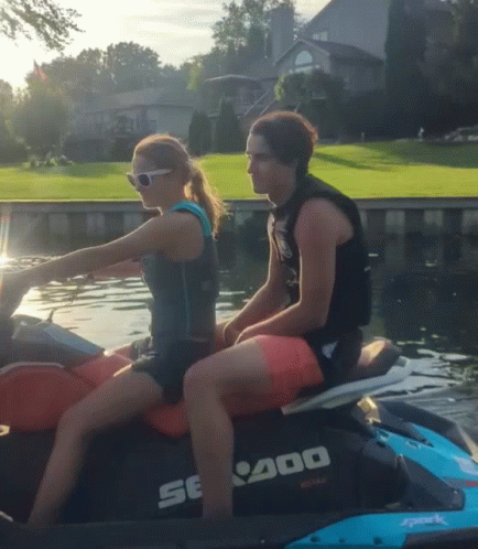 A Man And A Woman Are Riding A Se400 Jet Ski In The Water GIF